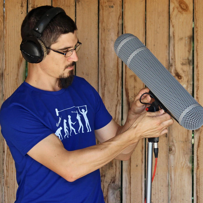 Un preneur de son avec un micro et un tshirt de perchman