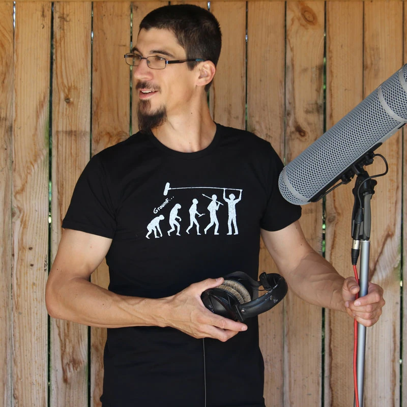 Un boom operator avec un micro et une perche